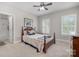 Inviting bedroom with two windows providing natural light, a wood-frame bed, and an ensuite bathroom at 320 Eden Hollow Ln, Weddington, NC 28104