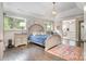 Inviting bedroom with a tufted headboard bed, neutral tones, and views into the ensuite bathroom at 320 Eden Hollow Ln, Weddington, NC 28104