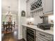 Butler's pantry features custom cabinets, a beverage refrigerator, a wine rack, and a view into the dining room at 320 Eden Hollow Ln, Weddington, NC 28104