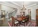 Dining room features a decorative chandelier, stairs to the second floor, and views to other living spaces at 320 Eden Hollow Ln, Weddington, NC 28104