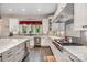 Kitchen with custom white cabinets, stainless steel appliances, gray backsplash, and a view into the yard at 320 Eden Hollow Ln, Weddington, NC 28104