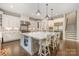 Spacious kitchen features an oversized island with seating, pendant lighting, and stainless steel appliances at 320 Eden Hollow Ln, Weddington, NC 28104