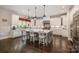 Bright eat-in kitchen features custom white cabinets, a gray island, and a large window overlooking the yard at 320 Eden Hollow Ln, Weddington, NC 28104