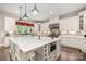Spacious kitchen features custom white cabinets, a large island, and stainless steel appliances at 320 Eden Hollow Ln, Weddington, NC 28104