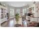 Well-lit home office featuring built-in shelving, hardwood floors, and a large desk at 320 Eden Hollow Ln, Weddington, NC 28104