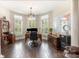 Well-lit home office features hardwood floors, built-in shelving, a large world map, and plantation shutters at 320 Eden Hollow Ln, Weddington, NC 28104