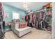 Spacious walk-in closet with custom shelving, seating, and a chandelier at 320 Eden Hollow Ln, Weddington, NC 28104