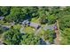 Aerial view of the property featuring a well-manicured lawn and lush trees at 3400 Barfield Dr, Charlotte, NC 28217