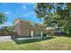 Spacious backyard showcasing the brick home, patio, and lush green lawn at 3400 Barfield Dr, Charlotte, NC 28217