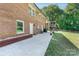 This backyard has a brick house and a concrete patio with outdoor furniture and a grill at 3400 Barfield Dr, Charlotte, NC 28217