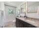 Bright bathroom featuring dual sinks, granite countertops, and a shower/tub combo at 3400 Barfield Dr, Charlotte, NC 28217