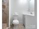 This bathroom features a toilet, sink and tiled shower with stone accents at 3400 Barfield Dr, Charlotte, NC 28217