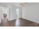 This bedroom has neutral walls, dark wood floors, and an open door to the bathroom at 3400 Barfield Dr, Charlotte, NC 28217