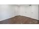 This bedroom has neutral walls, a dark wood floor, and a double closet at 3400 Barfield Dr, Charlotte, NC 28217