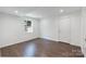This bedroom has a dark wood floor, neutral walls, and a large window at 3400 Barfield Dr, Charlotte, NC 28217