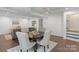 Dining area features hardwood floors, ceiling fan, and transitions to the living room and staircase at 3400 Barfield Dr, Charlotte, NC 28217