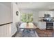 Bright dining area featuring white cabinets, stainless appliances, and a view of trees at 3400 Barfield Dr, Charlotte, NC 28217