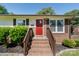 Close-up of the home's entrance, featuring a bright red door and brick steps at 3400 Barfield Dr, Charlotte, NC 28217