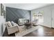 Bright living room with modern accent wall, hardwood floors, and ample natural light at 3400 Barfield Dr, Charlotte, NC 28217