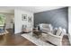 Cozy living room features hardwood floors, stylish decor, and a neutral color palette at 3400 Barfield Dr, Charlotte, NC 28217