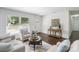 Inviting living room with hardwood floors, neutral furniture, and sun-lit windows at 3400 Barfield Dr, Charlotte, NC 28217