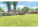 Large, well-maintained backyard with a grassy lawn and a wooden deck at 3932 Slagle Dr, Charlotte, NC 28215