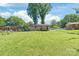 Spacious backyard with a large grassy area and a deck at 3932 Slagle Dr, Charlotte, NC 28215