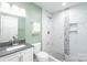 Renovated bathroom boasts a new vanity, toilet, and walk-in shower with elegant tile work at 3932 Slagle Dr, Charlotte, NC 28215