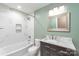Modern bathroom featuring a marble tile surround bathtub and a vanity with marble countertop at 3932 Slagle Dr, Charlotte, NC 28215