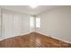 This room features hardwood floors, a double closet, and a window at 3932 Slagle Dr, Charlotte, NC 28215