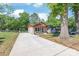Charming single story home with a long driveway leading up to the entrance, and mature landscaping at 3932 Slagle Dr, Charlotte, NC 28215