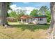 Charming single-story home with a well-maintained lawn and mature trees in a peaceful neighborhood setting at 3932 Slagle Dr, Charlotte, NC 28215