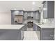 Updated kitchen with stainless steel appliances, gray cabinets, granite countertops, and an island at 3932 Slagle Dr, Charlotte, NC 28215