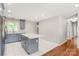 Open kitchen featuring gray cabinets, an island with countertops, stainless steel appliances, and new flooring at 3932 Slagle Dr, Charlotte, NC 28215