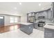 Open concept kitchen with gray cabinets, stainless steel appliances, and an island, flowing into the living area at 3932 Slagle Dr, Charlotte, NC 28215