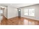 Inviting living area featuring hardwood floors, a gray front door, and large window for natural light at 3932 Slagle Dr, Charlotte, NC 28215