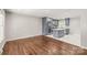 Spacious living room with hardwood floors that connects to the kitchen with updated cabinetry and stainless appliances at 3932 Slagle Dr, Charlotte, NC 28215