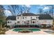 A backyard featuring a white brick home, patio, and a kidney-shaped outdoor swimming pool at 4001 Carmel Acres Dr, Charlotte, NC 28226