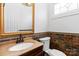 Charming powder room featuring a decorative mirror, stylish sink, and unique mosaic tile accent at 4001 Carmel Acres Dr, Charlotte, NC 28226
