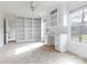 Bright bedroom boasting built-in shelving, a desk area, and views from two large windows at 4001 Carmel Acres Dr, Charlotte, NC 28226