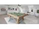 Bonus room offering versatile living space with a pool table and cozy seating area at 4001 Carmel Acres Dr, Charlotte, NC 28226