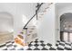 Inviting foyer features a staircase with dark rails and checkerboard flooring at 4001 Carmel Acres Dr, Charlotte, NC 28226