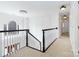 Bright hallway showcasing white trim, elegant chandelier, and view of window at the top of stairs at 4001 Carmel Acres Dr, Charlotte, NC 28226