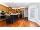 Open kitchen with stainless steel appliances, island, and hardwood floors at 4001 Carmel Acres Dr, Charlotte, NC 28226