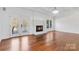 Inviting living room features a fireplace, hardwood floors, and natural light at 4001 Carmel Acres Dr, Charlotte, NC 28226