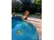 Inviting in-ground pool with a decorative sunflower mosaic and beautiful landscaping, ideal for summertime enjoyment at 4001 Carmel Acres Dr, Charlotte, NC 28226