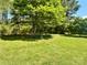 Expansive backyard featuring a lush lawn and mature trees, perfect for outdoor activities at 401 Overlook Dr, Monroe, NC 28110
