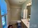 Neutral bathroom with shower-tub combo, vanity sink and blinds on the window at 401 Overlook Dr, Monroe, NC 28110