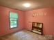 Pink bedroom featuring a window with natural light and basic furnishings at 401 Overlook Dr, Monroe, NC 28110