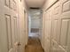 Hallway with multiple storage closets that leads to bedrooms at 401 Overlook Dr, Monroe, NC 28110